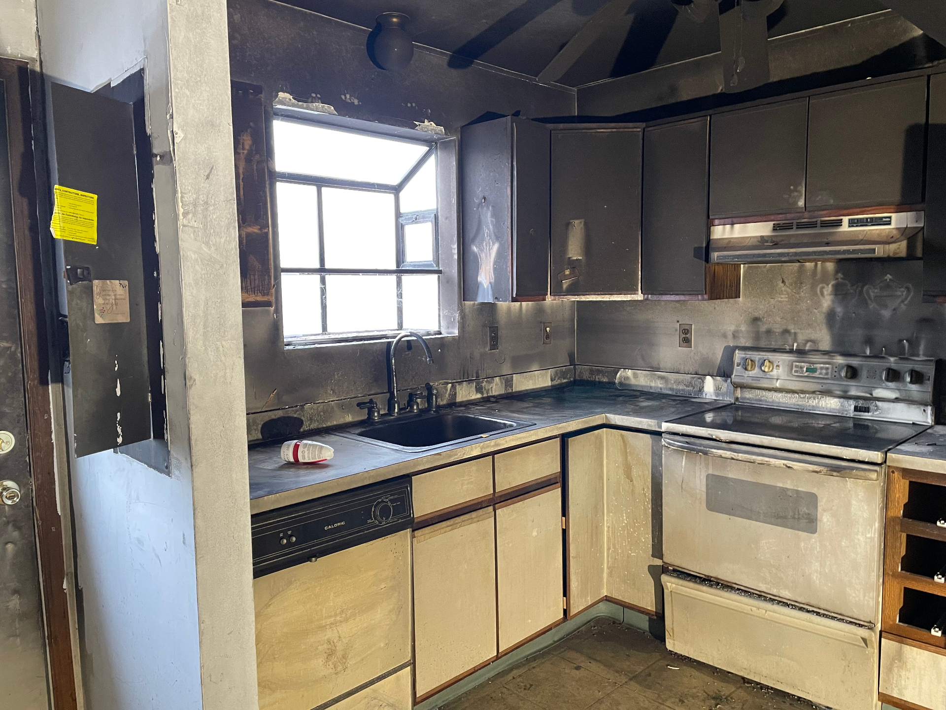 Fire-damaged kitchen before renovation — 4102 Channel Lane